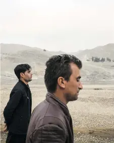  ??  ?? Inamullah and Ahmad Wali walk through what was supposed to be a zoo before funding dried up in the Deronta district of Jalalabad, Afghanista­n. Both men had fled West before they were forced to return to the country.