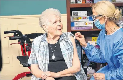  ?? PROVINCE OF P.E.I. ?? Doreen Wooder, a resident of the Wedgewood Manor in Summerside, receives a dose of the Moderna Vaccine on Jan. 8. P.E.I. has so far avoided significan­t outbreaks of COVID-19 within its long-term care sector.