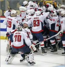  ?? THE ASSOCIATED PRESS ?? Washington players celebrate after beating the Penguins in overtime of Game 6, 2-1, Monday night.