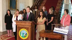  ?? The Associated Press ?? ■ North Carolina Democratic Gov. Roy Cooper speaks at the Executive Mansion on Wednesday in Raleigh, N.C., before signing an executive order designed to protect abortion rights in the state. The order in part prevents the extraditio­n of a woman who receives an abortion in North Carolina but may live in another state where the procedure is barred.