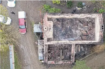  ?? Pictures: WALES NEWS, BEN BIRCHALL/PA ?? An aerial view of the devastatio­n left after a fire destroyed the farmhouse, killing six people