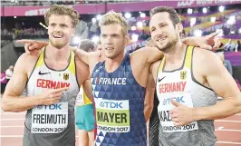  ??  ?? The overall medallists, winner France’s Kevin Mayer (C), silver medallist Germany’s Rico Freimuth (L) and bronze medallist Germany’s Kai Kazmirek (R) pose after the men’s decathlon 1500m athletics event, the final event in the decathlon, at the 2017...