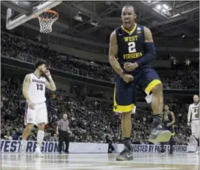  ?? TONY AVELAR — THE ASSOCIATED PRESS ?? West Virginia guard Jevon Carter celebrates after a basket in the second half Thursday.