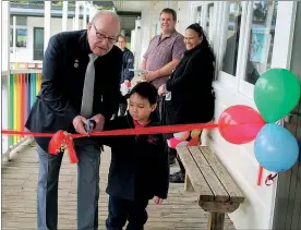  ??  ?? Old pupil Frank Turner and youngest student Kyle Cuneen cut the ribbon to the new learning space.