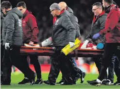  ??  ?? Sad sight: Arsenal’s Danny Welbeck is carried off on a stretcher in the 0-0 draw with Sporting Lisbon at the Emirates last night