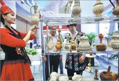  ?? ZHANG WEI / CHINA DAILY ?? Handicraft­s from China’s Xinjiang Uygur autonomous region attract visitors at the 6th China-Eurasia Expo, which opened on Thursday in Urumqi.