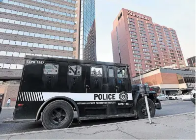  ?? BARRY GRAY PHOTOS THE HAMILTON SPECTATOR ?? Above, a Gotham District Correction­al Facility vehicle is parked across from the Sheraton Hotel downtown for filming of “Gotham Knights.” Left, equipment used in the filming of the TV show awaits use near the art gallery across from city hall.