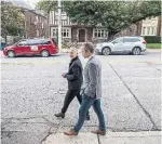  ?? NICK KOZAK FOR THE TORONTO STAR ?? Architect Healther Rolleston and developer Bill Gairdner walk across the street from a block of heritage quadplexes that inspired the pair’s masonry design for Leaside Common.