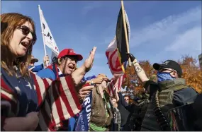  ?? AP PHOTO/DAVID GOLDMAN ?? Trump supporters, at left, demonstrat­ing the election results are confronted by counter protesters at the State Capitol in Lansing, Mich., on Saturday. Democrat Joe Biden defeated President Donald Trump to become the 46th president of the United States on Saturday, positionin­g himself to lead a nation gripped by the historic pandemic and a confluence of economic and social turmoil.