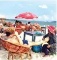  ?? HENG CHIVOAN ?? A Chinese tourist gets a massage at a beach in Sihanoukvi­lle in 2017.