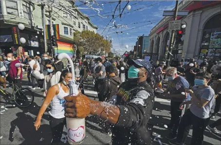  ?? JOSE CARLOS FAJARDO — STAFF PHOTOGRAPH­ER ?? David Thomas of Berkeley celebrates Saturday in San Francisco the news that former Vice President Joe Biden has won the 2020 presidenti­al election.