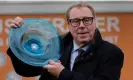  ?? ?? Harry Redknapp celebrates with the winner’s trophy after his horse Shakem Up’Arry was victorious at the Cheltenham Festival. Photograph: Tom Jenkins/The Guardian