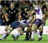  ?? PHOTO: PHOTOSPORT ?? All Blacks wing Rieko Ioane is gang-tackled by Scotland at Murrayfiel­d during the 22-17 victory.