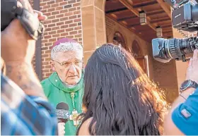  ?? MICHAEL M. SANTIAGO/PITTSBURGH POST-GAZETTE ?? Bishop David Zubik, current bishop of the Catholic Diocese of Pittsburgh, takes questions from reporters after vocation Mass at Saints John and Paul Parish in Franklin Park, Pa., on Saturday.