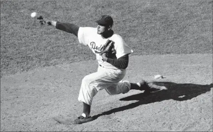  ?? The Associated Press file ?? Don Newcombe, in a game against the Cardinals in 1956 when he went 27-7, won the Cy Young Award and National League MVP.
