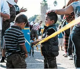  ?? GUILLERMO ARIAS/GETTY-AFP ?? Central American migrants wait at the U.S.-Mexico border in Tijuana. The U.S. is seeking a solution to the border crisis.