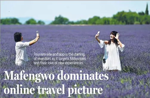  ??  ?? Chinese tourists make selfies in a lavender field in Valensole, southern France, on June 18, 2017.