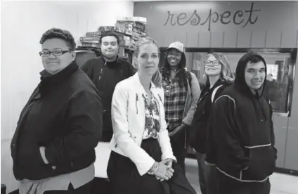  ?? John Leyba, The Denver Post ?? Christina Carlson, CEO of Urban Peak, front center, poses with, from left, Ilicia G, 19; John Carlo, 19; Bayley Bamrick, 19; Kaya Mccrae, 19; and Randy Contreras, 19, at the shelter earlier this month in Denver. Urban Peak is the only nonprofit...