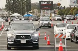  ?? Al Seib Los Angeles Times ?? DRIVERS remain in their vehicles while being monitored to ensure they suffer no adverse reaction to the COVID-19 vaccine at the Forum in Inglewood in January.