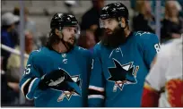  ?? NHAT V. MEYER — BAY AREA NEWS GROUP FILE ?? Sharks defensemen Erik Karlsson (65) and Brent Burns (88) talk during a break in play in the third period of a game against the Calgary Flames at SAP Center in San Jose.