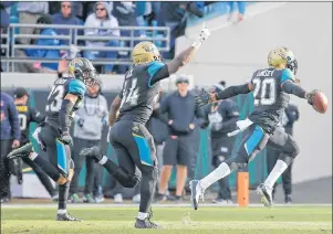 ?? AP PHOTO ?? Jacksonvil­le Jaguars cornerback Jalen Ramsey ( 20) celebrates with a teammate after intercepti­ng a pass against the Buffalo Bills in the final seconds an NFL wild- card playoff football game, Sunday, in Jacksonvil­le, Fla.