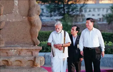  ?? XU JINGXING / CHINA DAILY ?? President Xi Jinping walks with Indian Prime Minister Narendra Modi after he arrives in Chennai, India, on Friday. Xi’s trip, which extends into the weekend, includes a second informal summit with Modi and the first visit to Nepal by a Chinese president in 23 years.