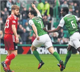  ??  ?? McGinn celebrates his opening goal as the holders marched on