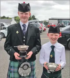  ??  ?? Christophe­r and Euan McCartan each won first place in the piping.