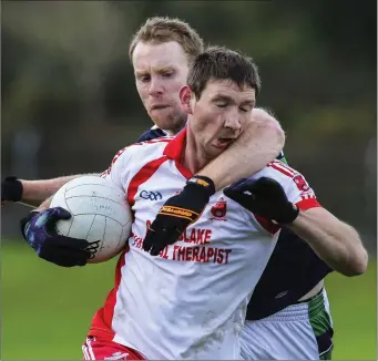  ??  ?? Bray’s Rory Breslin challenges Tinahely’s Brian Walsh during the Keating Trophy match in Pearse’s Park.