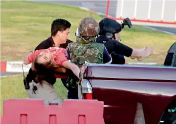  ?? — AP ?? Armed soldiers carry a person out of Terminal 21 Korat mall in Nakhon Ratchasima, Thailand, Sunday