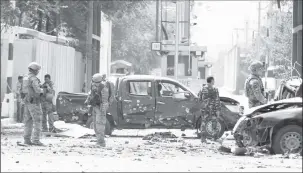  ?? REUTERS/Omar Sobhani ?? Foreign troops with NATO-led Resolute Support Mission investigat­e at the site of a suicide attack in Kabul, Afghanista­n September 5, 2019.