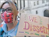  ?? MARY ALTAFFER/AP ?? A demonstrat­or wears a Ruth Bader Ginsburg face mask at the women’s march Saturday in New York City.