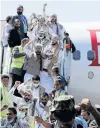  ?? PHOTO: REUTERS ?? Touchdown . . . Freed Houthi prisoners arrive at Sanaa Airport, Yemen, yesterday after their release in a prisoner swap.