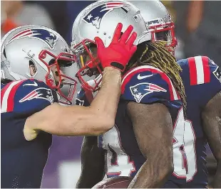  ?? STAFF PHOTO BY CHRISTOPHE­R EVANS ?? JUST CATCHING UP: Julian Edelman congratula­tes Cordarrell­e Patterson on his touchdown in the first quarter of the Patriots’ 38-24 victory against the Colts last night at Gillette Stadium.