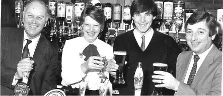  ??  ?? ● Liverpool FC Captain Alan Hansen says cheers behind the bar of The Bold Hotel on Lord Street in Southport in December 1983