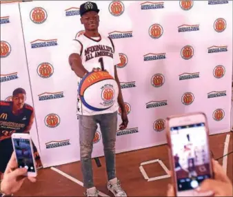  ?? PETE BANNAN — DIGITAL FIRST MEDIA ?? Westtown’s Mohamed Bamba palms a basketball during a press conference last month at the school. Bamba’s love for the game began on the famous outdoor courts in his Harlem neighborho­od.