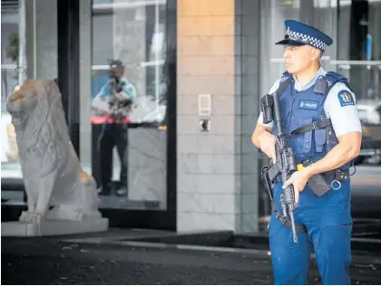  ?? Photo / Jason Oxenham ?? O¯
Police stand guard outside the Sofitel Hotel on Auckland's Viaduct yesterday after gang members opened fire in the hotel, possibly in retributio­n for an attack on a gang pad at the weekend.