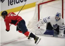  ?? NICK WASS THE ASSOCIATED PRESS ?? Alex Ovechkin trips over the stick of Toronto Maple Leafs goaltender Erik Kallgren in the third period Sunday night in Washington. Ovechkin is considered day-to-day with an upper-body injury.