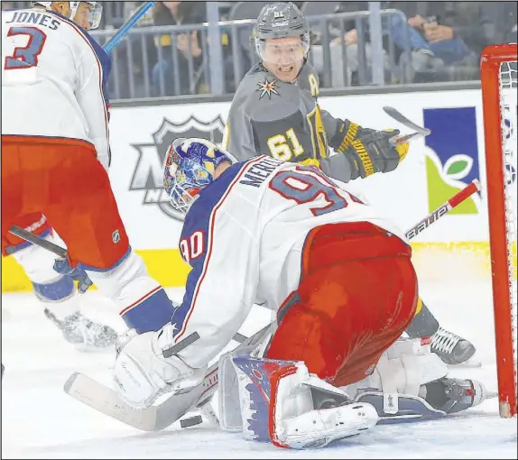  ?? Chase Stevens Las Vegas Review-Journal @csstevensp­hoto ?? Columbus goaltender Elvis Merzlikins stops a shot by Golden Knights right wing Mark Stone in a 3-0 Blue Jackets’ victory Saturday night.