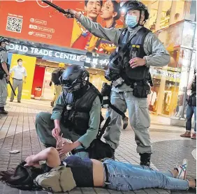  ?? PHOTO: VINCENT YU/AP ?? Unrest: Hong Kong Riot police detain a protester during a protest in Causeway Bay, Hong Kong, yesterday.