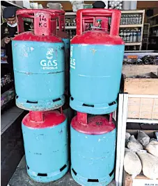  ??  ?? The cooking gas cylinders displayed at the sundry shop without price tags.