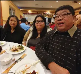  ?? PHOTO COURTESY OF HEAK HUOCH ?? Kim Phoeu is flanked by her mother, Soktea Hok, and her father, Sreng Hok, in this family photo. Kim died Thursday after suffering a brain aneurysm in late April. One of her kidneys was transplant­ed into her father; her other kidney and her liver went to two other people.