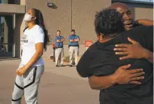  ?? Julia Hansen / New York Times ?? Maya Moore exults as Jonathan Irons (far right) is released from the Jefferson City Correction­al Center in Missouri.