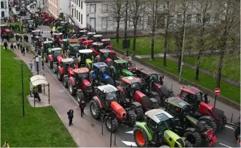  ?? BERNARD BARRON/AGENCE FRANCE-PRESSE ?? FISHERMEN and farmers parade with tractors during a protest in Boulogne-sur-Mer, northern France. They are protesting against tax policies and demanding for administra­tive simplifica­tions and better income.