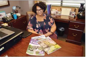  ?? TAMMY KEITH/RIVER VALLEY & OZARK EDITION ?? Adena White sits in her office at the Conway Area Chamber of Commerce, where she is director of communicat­ions. Displayed are three of the publicatio­ns she manages. White was inducted in January as the first black president in the 55-year history of the Arkansas chapter of the Public Relations Society of America. White said her family, friends and co-workers have celebrated her achievemen­t.