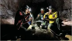  ?? AP ?? Timeless: Some of volunteers eat a meal together inside the cave