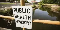  ?? Brian A. Pounds / Hearst Connecticu­t Media ?? A public health advisory sign near Ferry Creek in Stratford, where much of Raymark’s toxic materials were dumped and never cleaned up.