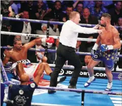  ?? DANIEL LEAL-OLIVAS/AFP ?? British boxer David Haye (left) sits on the canvas as boxer Tony Bellew is sent to his corner during their heavyweigh­t rematch at the O2 Arena in London on Saturday.