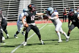  ?? JOSE QUEZADA, HUMEDIA — FOR THE TIMES-STANDARD ?? College of the Redwoods quarterbac­k Brody Lucero avoids a sack during a 21-14loss to visiting Cabrillo College during the 2019 season. The College of the Redwoods announced that the fall football season is suspended.