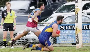  ??  ?? Ellinbank’s Keegan Bott marks running towards goal in front of Warragul Industrial­s player Josh Peterson. Bott converted to set up an early lead for the home side.